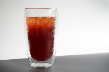 Delicious ice of americano isolate in 2 layer glass on white and gray background  