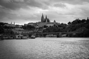 Fototapeta premium Prague castle in black and white at sunset, seen from a cruise on the Vltava river in Prague city center