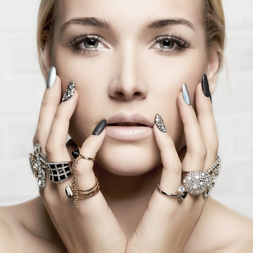 beauty face.woman's hands with jewelry