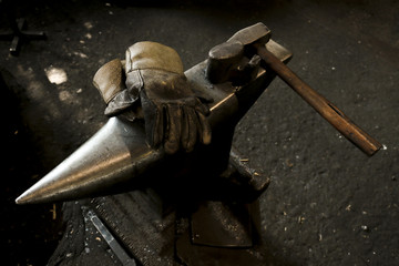Blacksmith's workshop. Working metal tools in smithy. Close-up shot of forge consisting of old...