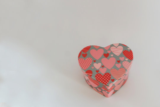 Close-up of heart-shaped jewelry box on white background. Concept holiday.