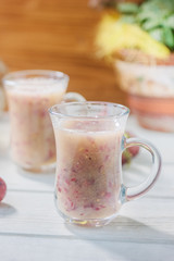 Grape smoothie over the white table.
