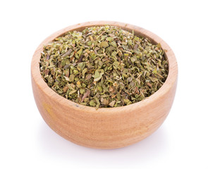 Dried Oregano in wooden bowl on white background