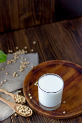 Soy milk with soy beans around it.