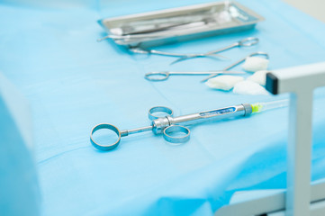 Dental tools and syringe at dentist's surgery table on the background of . Selective focus. Space...