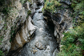 Top view of mountain river in mountain gorge between the rocks