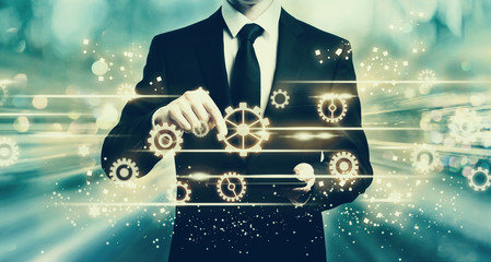 Gears with man holding a tablet computer