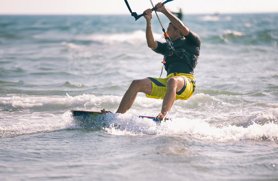 Kitesurfing, Kiteboarding action photos, man among waves quickly goes