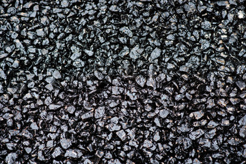 Texture of black granules of fresh asphalt that been already paved