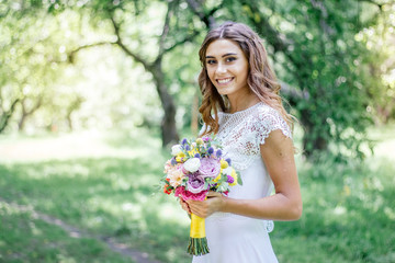 Naklejka premium Wedding scene - bride with flower bouquet outdoor