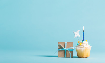 Cupcake with candle and present box celebration theme