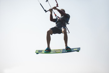 Kiteboarder athlete performing kiteboarding kitesurfing tricks unhooked