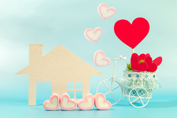 Home and marshmallows and vintage bicycle model transport a red heart for supporting when people get who lack of desire with love and Valentine's Day concept.