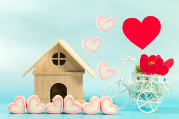 Home and marshmallows and vintage bicycle model transport a red heart for supporting when people get who lack of desire with love and Valentine's Day concept.