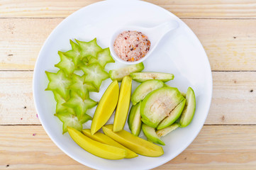 star apple, mango pickle, olive with chili & salt sauce on white dish