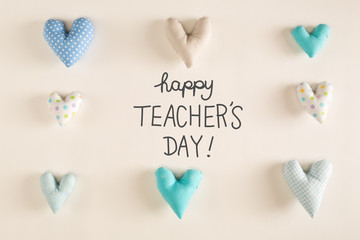Teacher's Day message with blue heart cushions on a white paper background