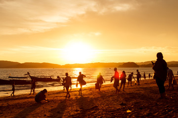 Silhouette people on beach when sunset tine