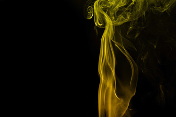 Movement of yellow smoke abstract on black