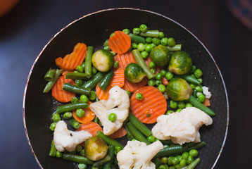 roasted vegetables in a frying pan, a vegetable stew on top,