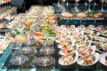 buffet shrimp cocktail in wine glasses with Bacon wrapped asparagus