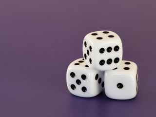 Three white dices lying on a table