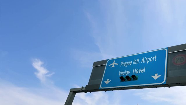 airplane flying over prague airport signboard