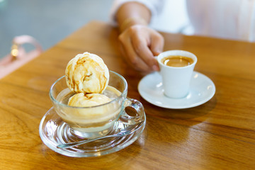 affogato with business women hand holding espresso coffee in white cup background.