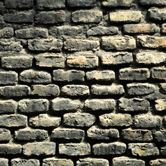 Blackened brick wall, industrial texture