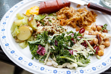 Healthy salad plate with quinoa, potatoes, chicken, avocado, lime and mixed greens, lettuce, parsley