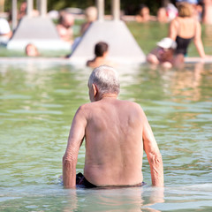 Old man resting in pool