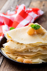 Homemade  crepes served with fresh yelllow raspberries