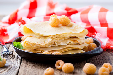Homemade  crepes served with fresh yelllow raspberries