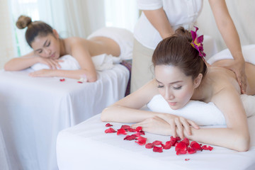 Obraz na płótnie Canvas beautiful and healthy woman enjoying during a back massage in spa salon