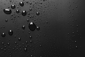 Water drops on rough black surface