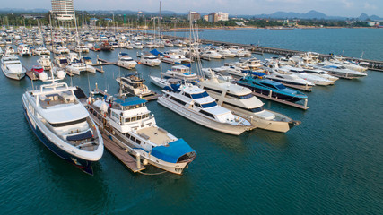 Obraz premium Pier speedboat. A marina lot. This is usually the most popular tourist attractions on the beach.Yacht and sailboat is moored at the quay.Aerial view by drone.Top view.