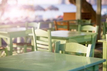 Tables and chairs in a street restaurant in Kamari on Santorini