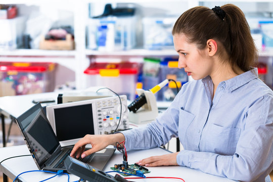 Young woman in electronics repair service center