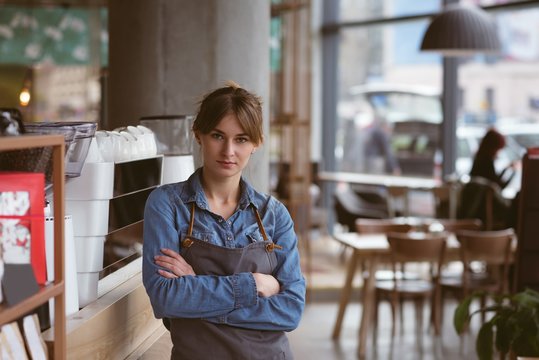 Portrait of waitress standing in cafe