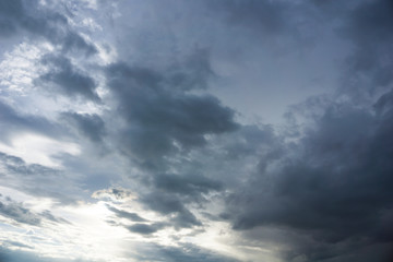 blue cloudy sky with golden sun ray at dusk