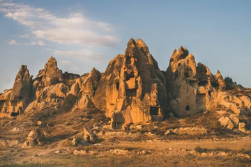 Wall murals Middle East Natural volcanic rocks with ancient cave houses in Goreme Open Air museum in Cappadocia, Central Anatolia region of Turkey, at sunset on clear day
