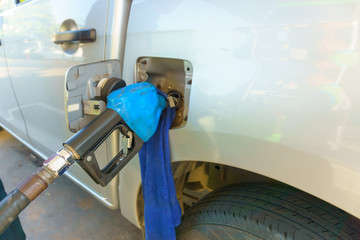 petrol pump nozzle filling oil gas fuel to the car