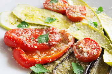 bell pepper, zucchini, aubergine and tomatoes dressed with lemon juice, olive oil, garlic and fresh herbs marinade sprinkled with cheese and decorated with parsley leafs
