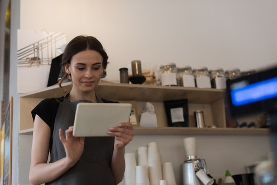 Female owner using digital tablet