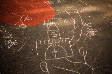 Children drawing chalk on the ground