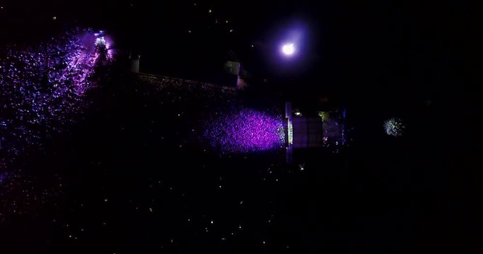  a crowd of people at a concert. drone point of view