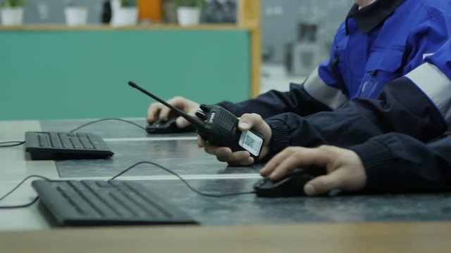 Closeup Workers Sit at Table Work on Computers against Office