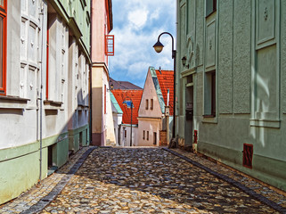 Narrow street covered with stone blocks in the town of Tábor, Czech Republic