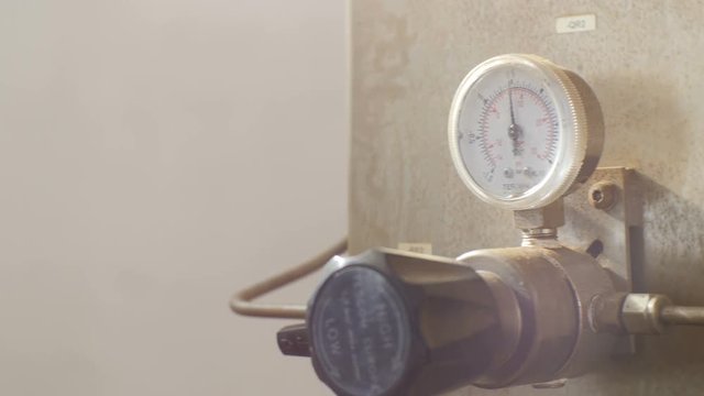 Closeup Camera Moves Past Measuring Device Settled in Workshop