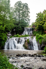 Fototapeta na wymiar Cascaded waterfall in a green forest. Dzhurinsky waterfall Ukraine.