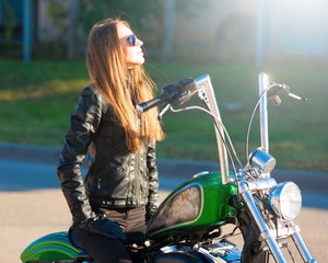 Fototapeta na wymiar Woman riding motorcycle. Black jacket. Close up